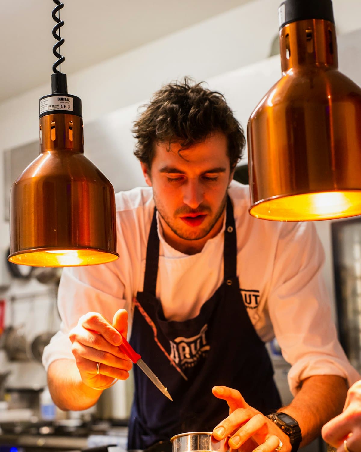 A chef working with focus in a kitchen.